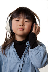 Girl wearing headphone calmly listening to music