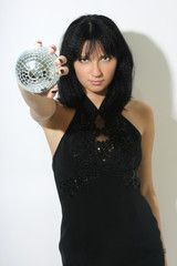 Beautiful woman with discoball in hand