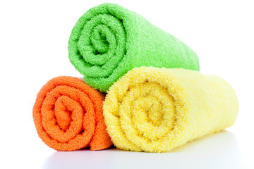 stack of fresh colorful towels rolls isolated