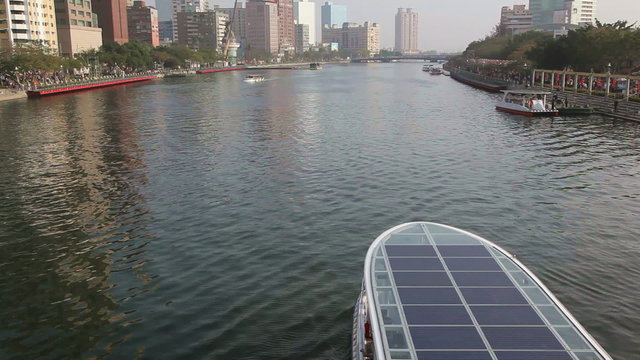Solar boat cruising along the River