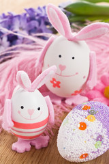 Easter rabbit egg decoration with flower and feather