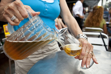Beer Waitress Bar Maid pouring draught beer from a pitcher