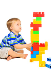 Cute little boy is playing with building blocks