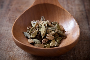 cardamom on wooden spoon