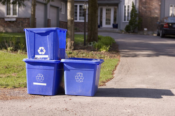 Three small recycle bins on curb