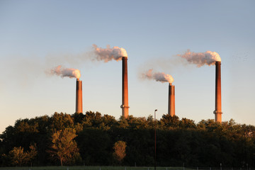 Industrial Smokestacks at Sunset