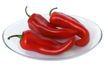 Ripe red peppers on a white background