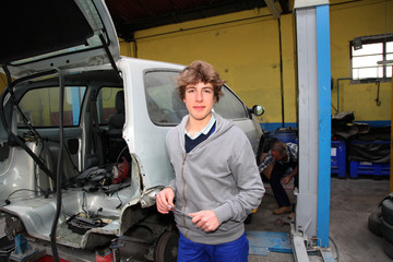 Fototapeta na wymiar Portrait of teenager in mechanics apprenticeship