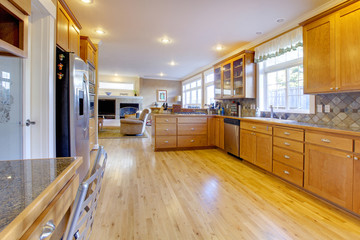 Maple wood cabinets in a large kitchen.