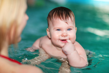 Swimming baby in pool water