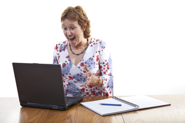 Happy ecstatic business woman working on a laptop