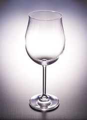 A glass and lighting a dark desktop.