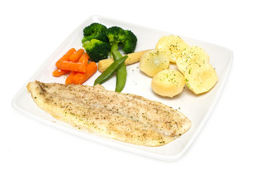 cod fillet with vegetables on white