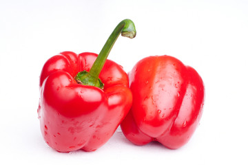 two red paprikas on white background