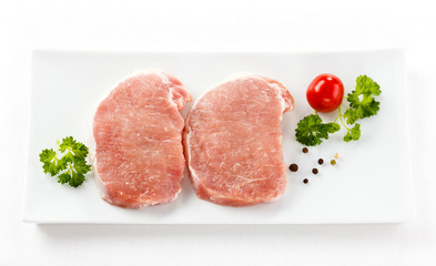 Fresh raw pork on white plate