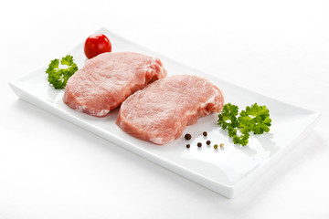 Fresh raw pork on white plate