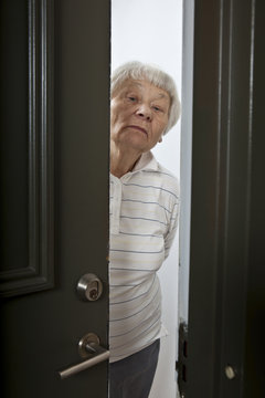 Annoyed Senior Woman Answering Front Door