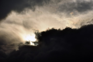 pale light through black clouds