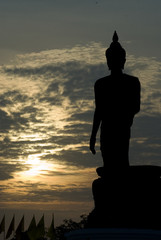 Fototapeta premium Big standing Buddha in sunset.