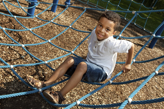 Young boy playing at a park - Powered by Adobe