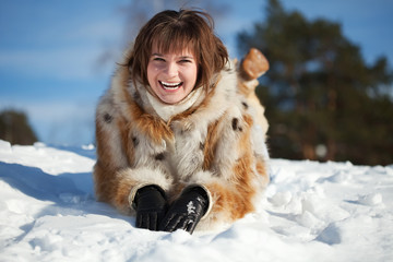 Young woman lying on  snow