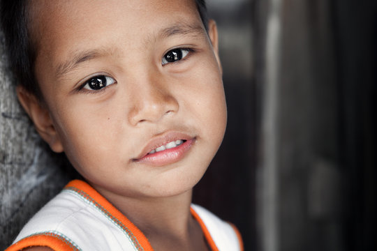 Young impoverished Asian boy portrait in Philippines
