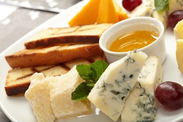 Cheese plate with grapes and honey