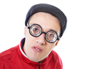 Portrait of a young nerd in funny glasses isolated on white