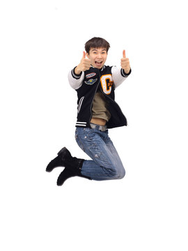 Young trendy stylish teenager jumping in joy isolated