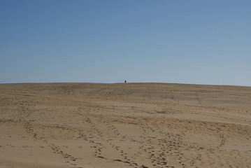 Fototapeta na wymiar sand dunes with man on top in North Carolina