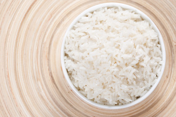 Rice in a bowl on a bamboo plate