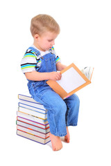 Cute little boy is reading a book