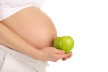 belly pregnant woman with an apple in profile