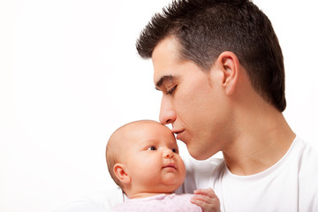 Young father gently  kissing his angelic two months daughter