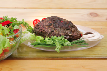 roastbeef on plate with salad bowl