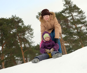 Fototapeta na wymiar child sliding in the snow
