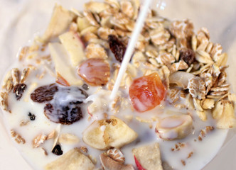 Breakfast cereal with milk being poured