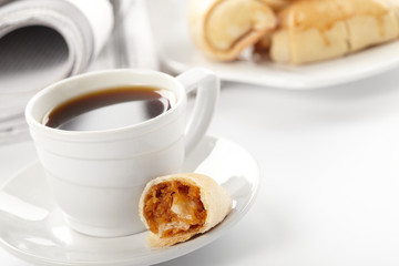 Cup of fragrant coffee on a morning paper business news
