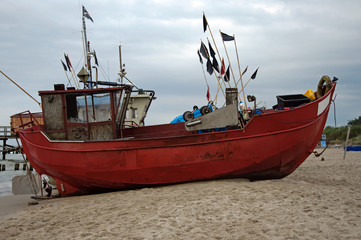 Naklejka na ściany i meble Fishing boat on the beach