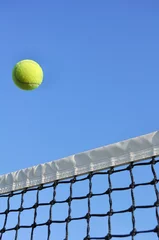 Zelfklevend Fotobehang Yellow Tennis Ball Flying Over the Net © Mark Herreid