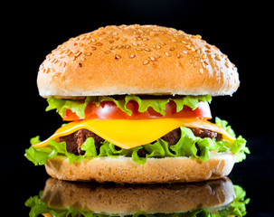 Tasty and appetizing hamburger on a dark