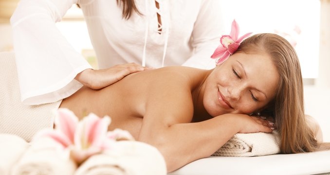 Smiling woman enjoying back massage