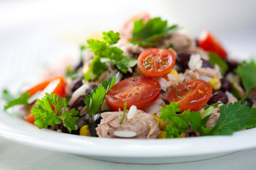 Freshly prepared rice and vegetable salad with tuna and herbs