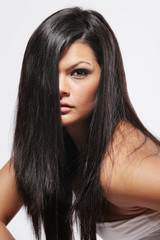 Naklejka premium Attractive woman with long black hair on white background.