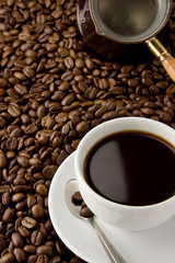 cup of coffee and pot on beans