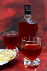 lemon alcohol drink is in a bottle and glass