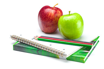 apple, notebooks and pencils isolated on white