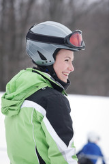 Teen Skier against background of snow and woods.