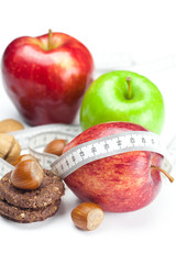 apple, nuts, cookies and measure  tape isolated on white