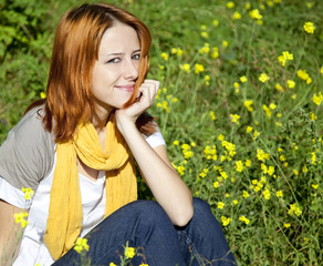Young girl in the yellow flowers field.